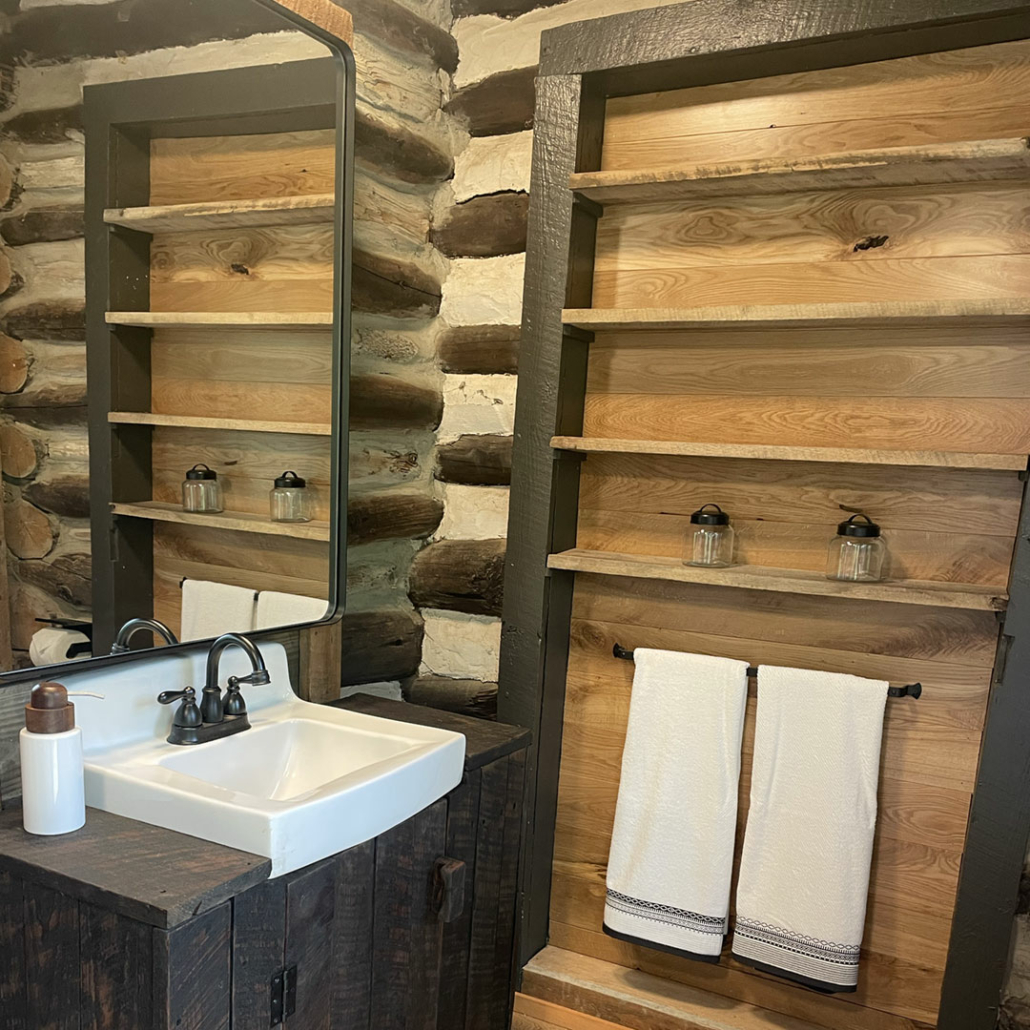 Rustic bathroom, one of the log home restoration projects in Renovation Hunters’ Project Hiwassee.