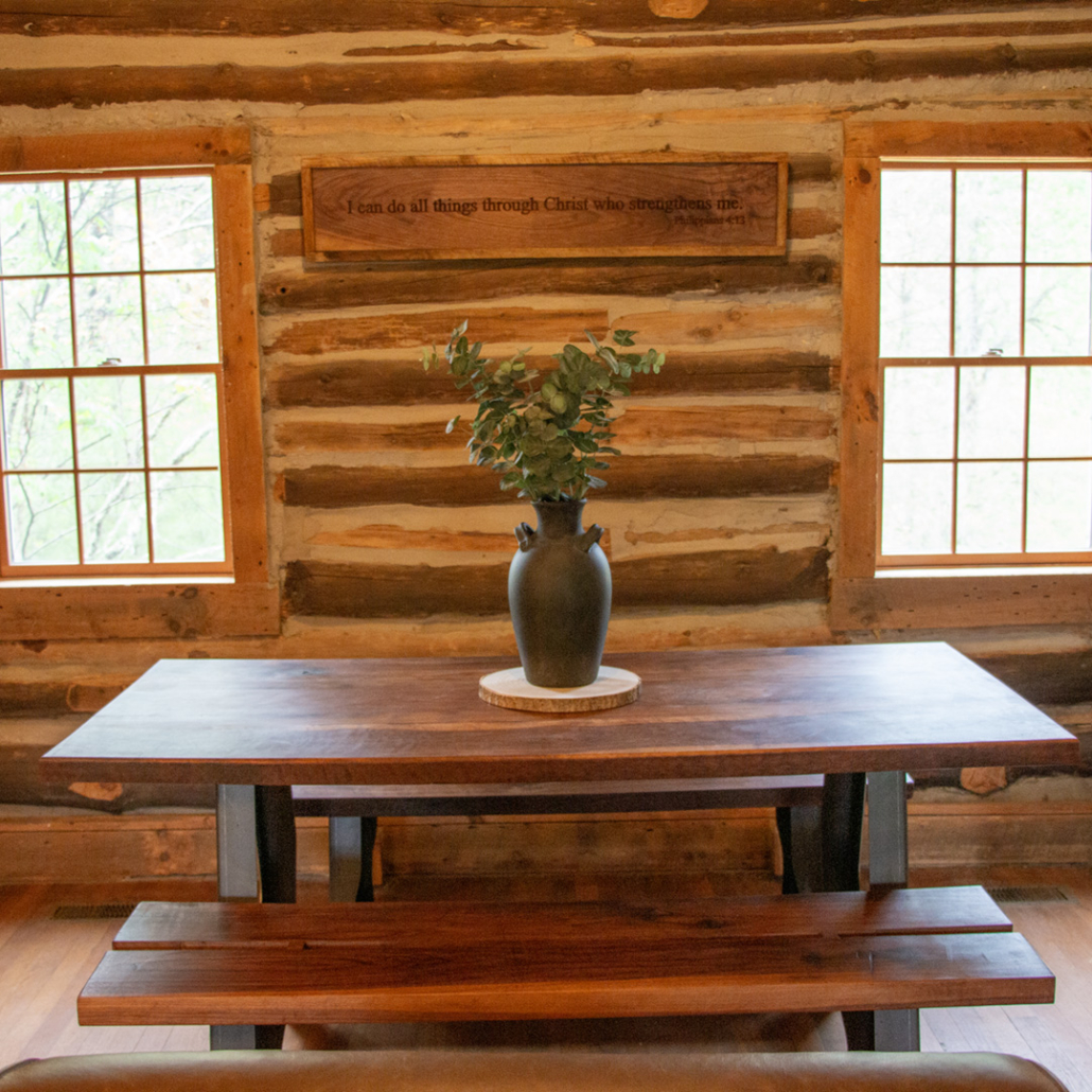 Beautiful hardwood dining table at the heart of Renovation Hunters’ log home restoration project.