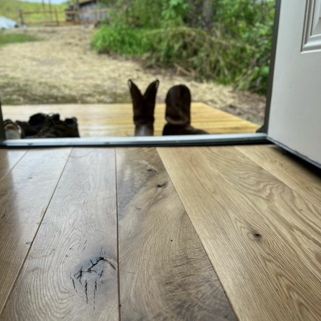 New hardwood floors installed as part of Renovation Hunter’s log cabin repair.