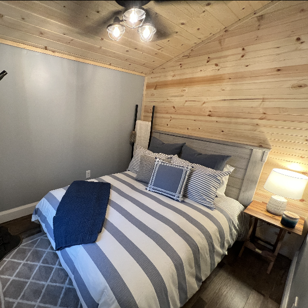 Primary bedroom in the tiny home makeover from Renovation Hunters season 2.