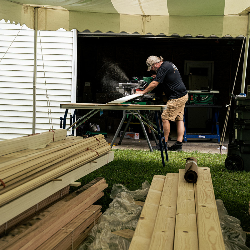 Cutting lumber to size to upgrade an old mobile home.